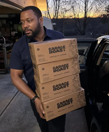 Garage Roast's owner carrying boxes